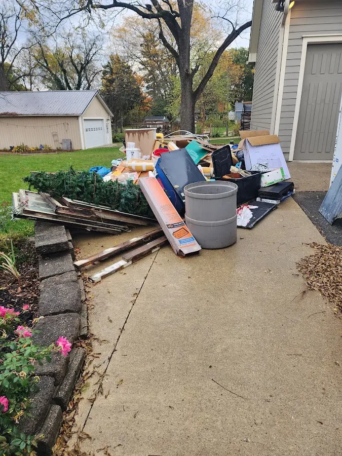 Dumpster being loaded with debris for Estate Cleanout Dumpster Rental in Lewisville
